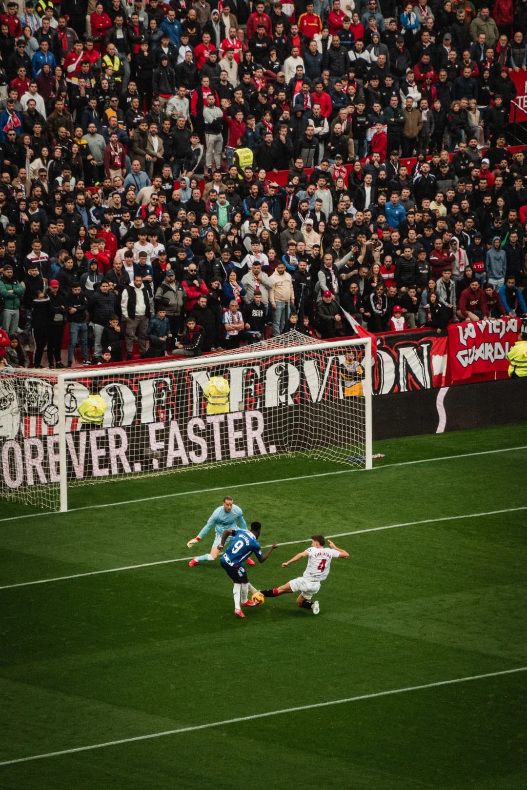 A shot on goal in front of the Sevilla ultras