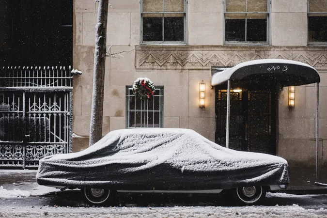 Car buried in snow outside a Manhattan doorway