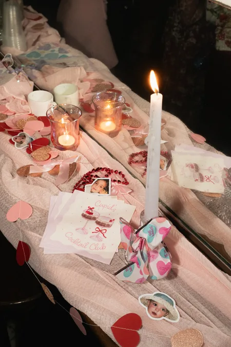 Valentine's table set with candles and paper hearts
