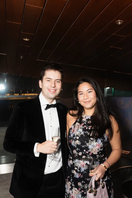 Guests in black tie with champagne
