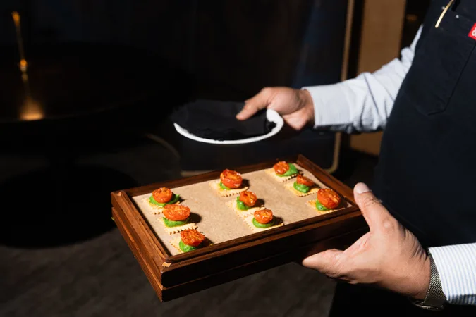 Server carrying a tray of canapes