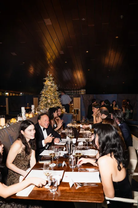 Long table in conversation beside the tree