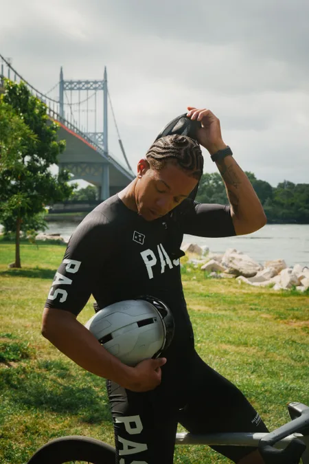 Cyclist pulling off his glasses by the East River