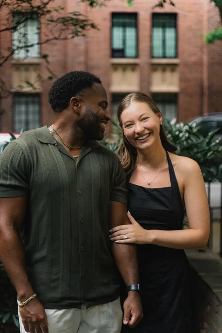 Couple laughing together on a brick-lined block