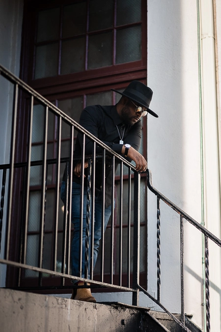 Kal looking over a fire escape