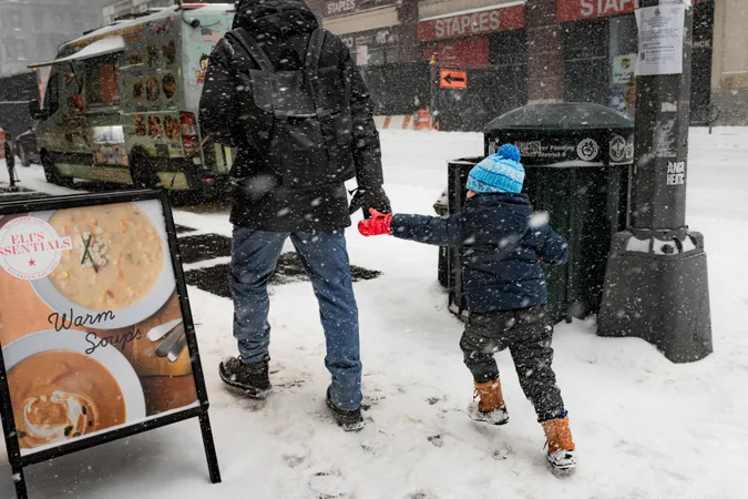Father and child crossing a snowy Manhattan sidewalk