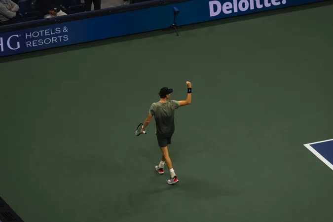 A player raising a fist after winning the point, seen from above