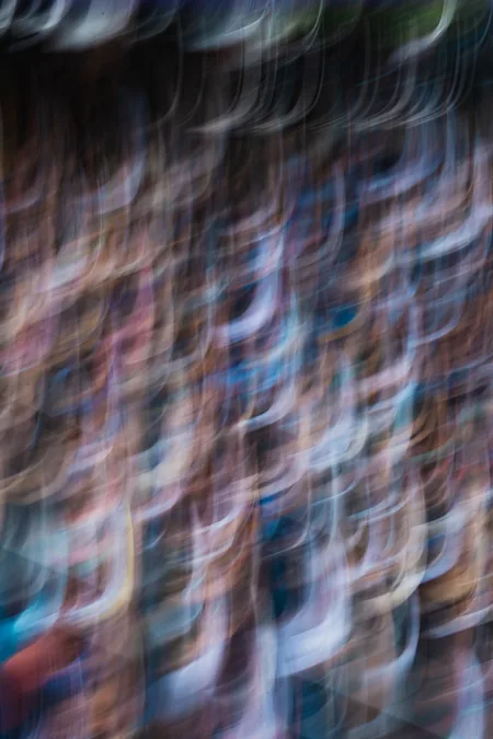 A crowd dissolved into vertical smears of colour
