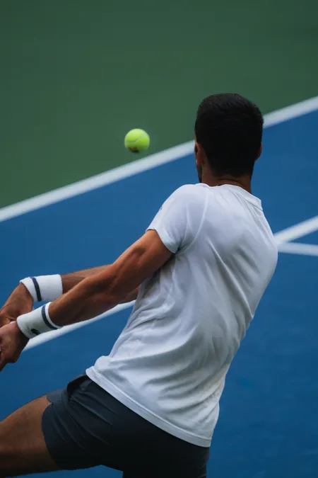 Backhand met at shoulder height, ball hanging in the frame