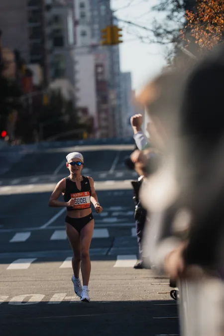 Seidel alone on First Avenue as spectators lean over the barrier