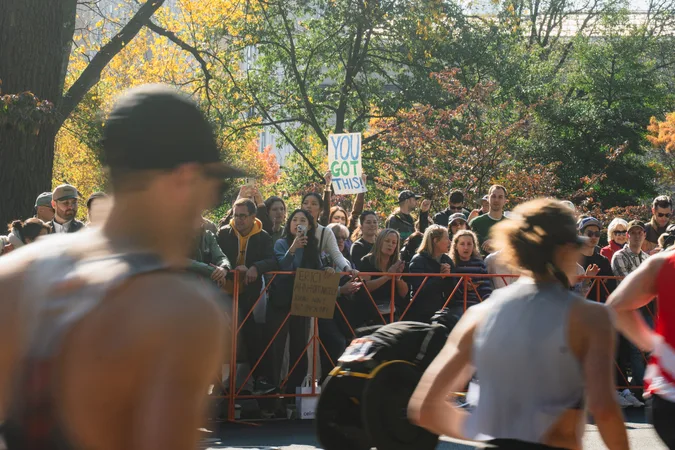 Crowd blurred past a "You Got This" sign in Central Park