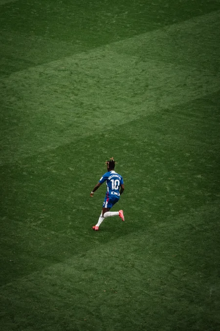 A number 10 running into open grass at Sevilla